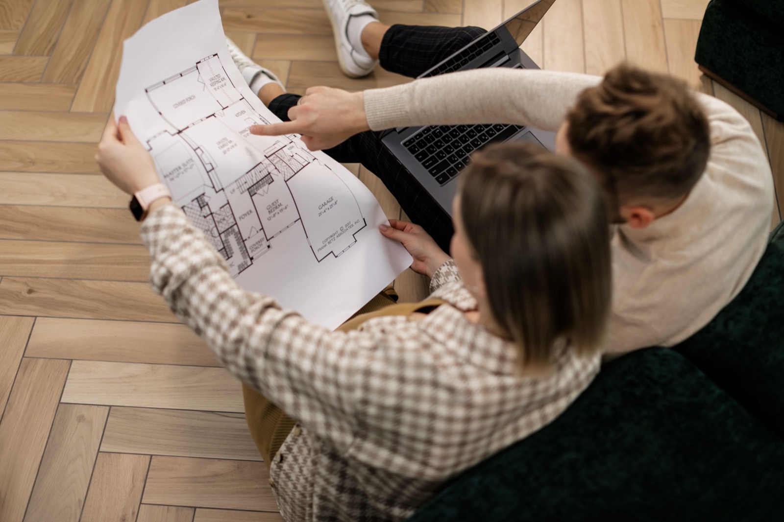 A couple reviewing a home's floor plan together
